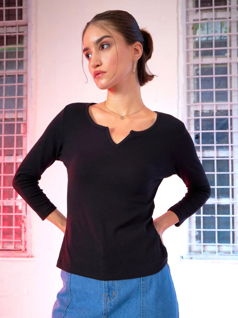 Women’s black long sleeve V neck t shirt with notch detail – fitted casual top paired with blue jeans.